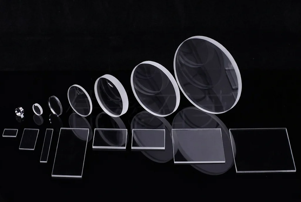 Round, square and rectangular optical windows in multiple sizes on a black background
